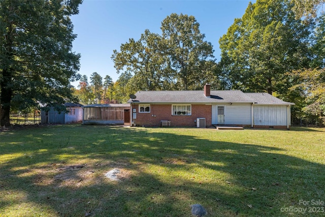 exterior space with central AC unit and a front yard