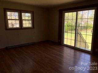 unfurnished room with dark hardwood / wood-style flooring