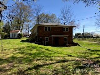 back of house with a lawn