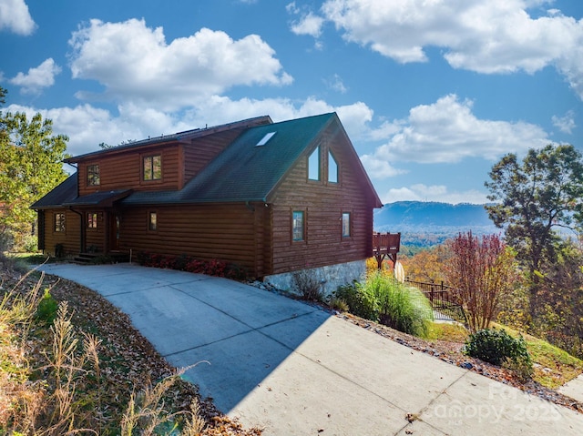 view of property exterior with a mountain view