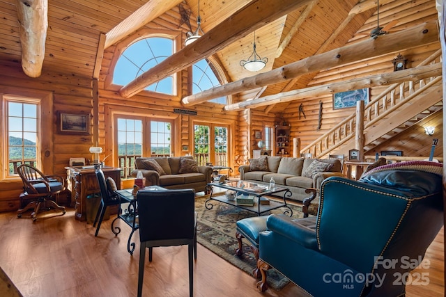 living room with wood ceiling, log walls, high vaulted ceiling, and beamed ceiling