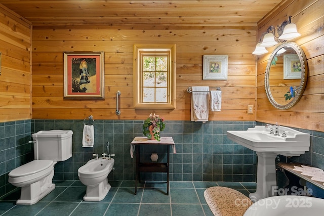 bathroom with a bidet, toilet, tile patterned flooring, and wooden ceiling