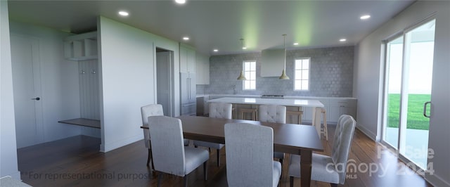 dining room featuring dark hardwood / wood-style floors and a healthy amount of sunlight