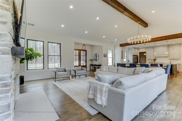 living room with beamed ceiling, a chandelier, high vaulted ceiling, and light wood-type flooring