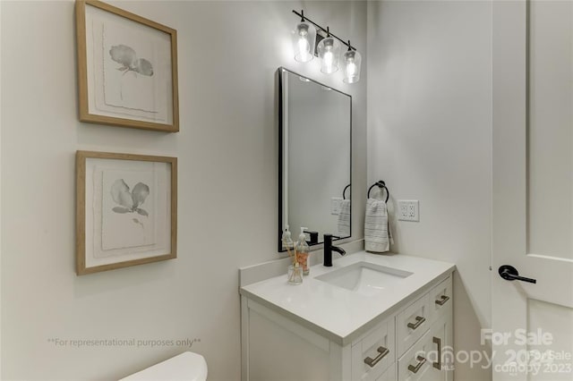 bathroom featuring toilet and vanity