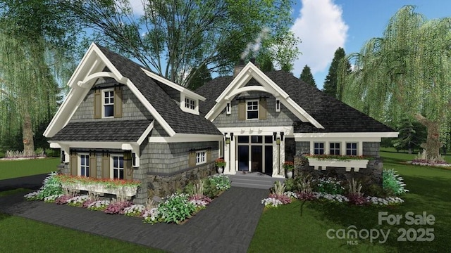 view of front of property featuring stone siding, a front lawn, and roof with shingles