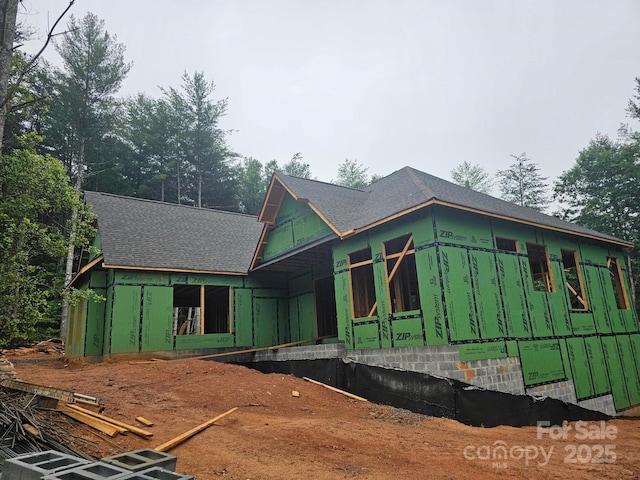 view of front of house with a shingled roof