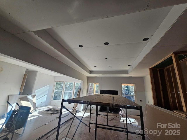 game room with a tray ceiling