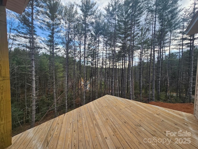 wooden deck featuring a wooded view