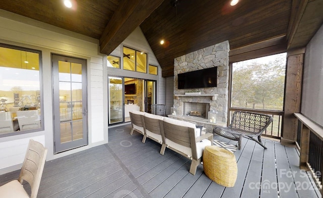 sunroom featuring a fireplace, lofted ceiling with beams, a wealth of natural light, and wood ceiling