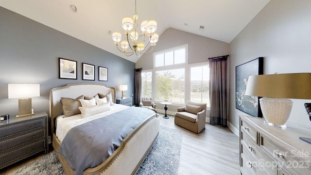 bedroom with high vaulted ceiling, a notable chandelier, and light wood-type flooring