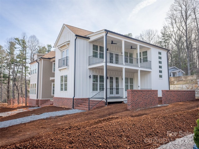 view of front facade featuring a balcony, french doors, and ceiling fan