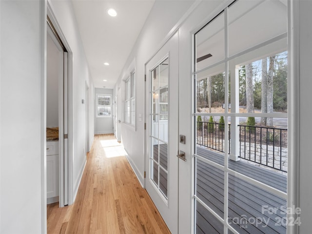 hallway with light hardwood / wood-style floors