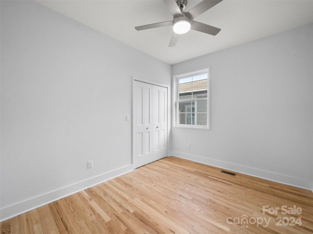 empty room featuring ceiling fan and hardwood / wood-style floors