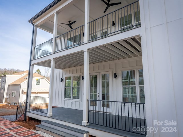 entrance to property with ceiling fan, french doors, and a balcony