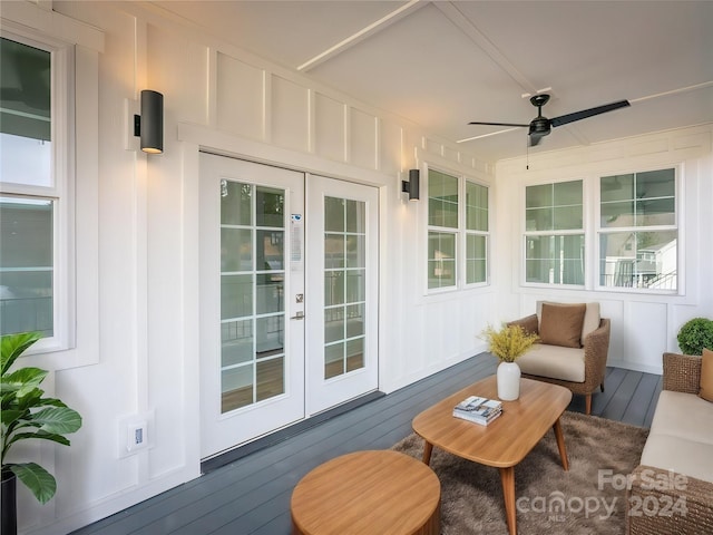 sunroom / solarium with ceiling fan and french doors