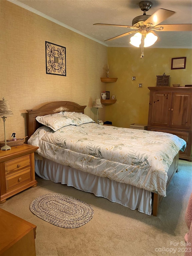 carpeted bedroom featuring crown molding and ceiling fan