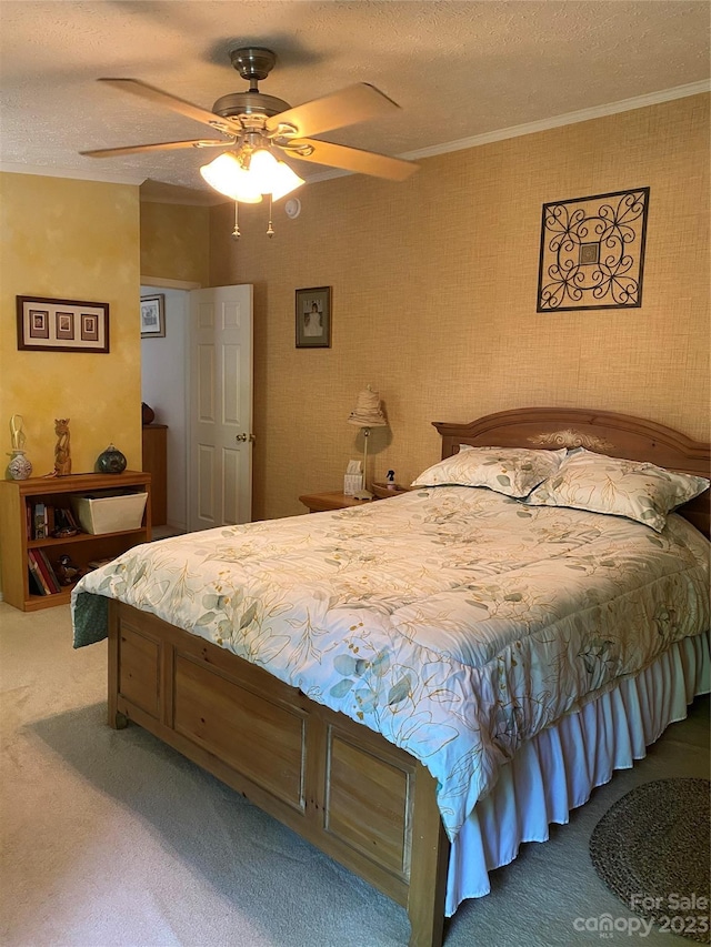 carpeted bedroom with ceiling fan and a textured ceiling