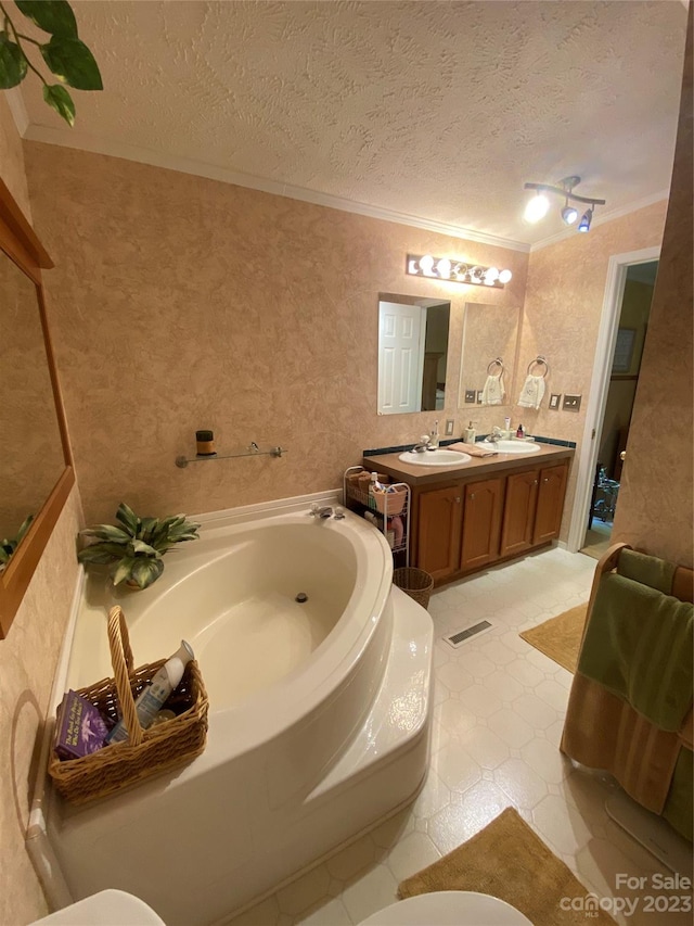 bathroom featuring a tub, a textured ceiling, tile floors, and double vanity