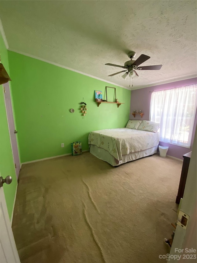 unfurnished bedroom with ornamental molding, a textured ceiling, ceiling fan, and carpet