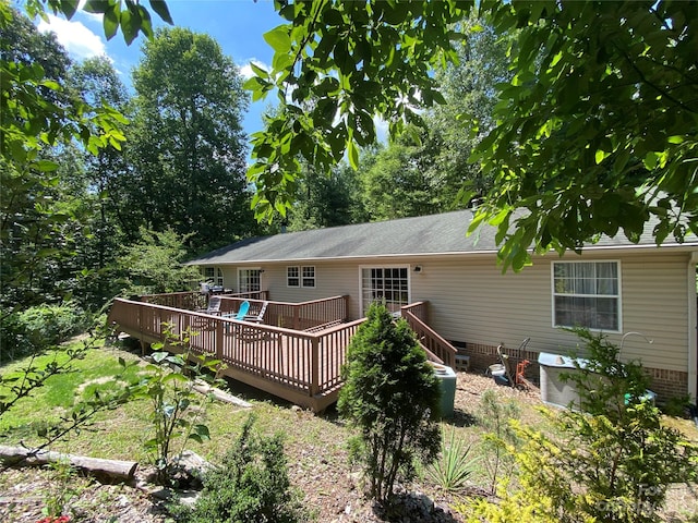 rear view of property featuring a deck