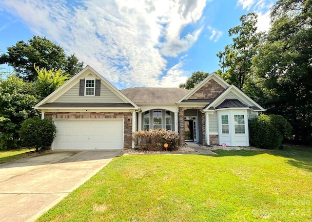 craftsman house with a front yard and a garage