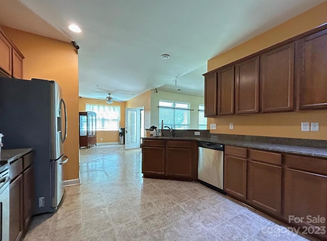 kitchen with light tile floors, ceiling fan, appliances with stainless steel finishes, dark brown cabinetry, and sink