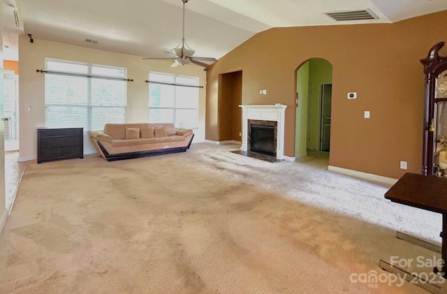 unfurnished living room featuring light carpet, lofted ceiling, and ceiling fan