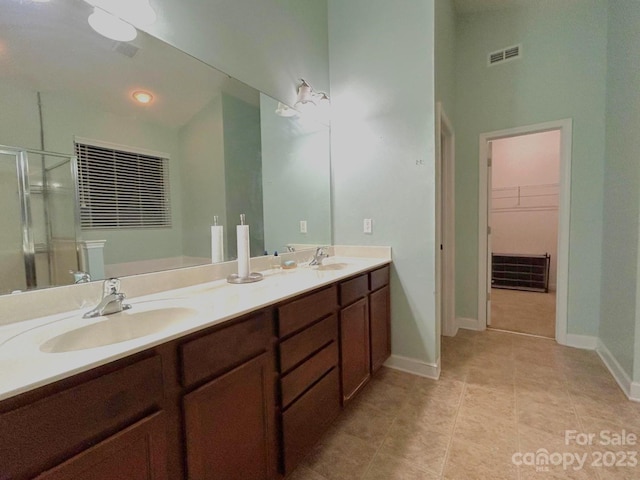 bathroom with tile floors, double sink, and oversized vanity