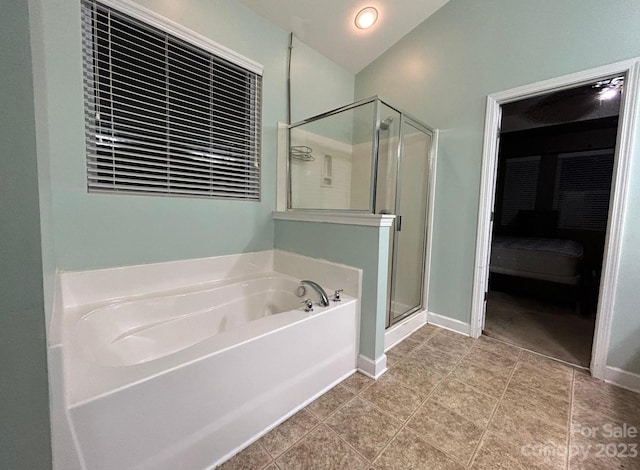 bathroom with independent shower and bath and tile flooring