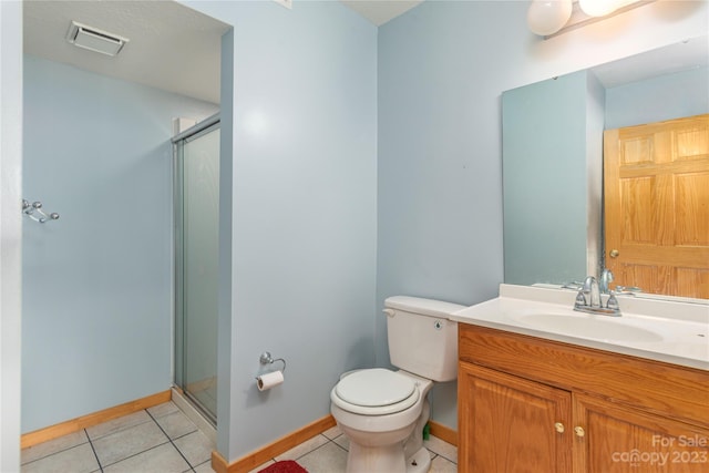 bathroom with vanity, tile floors, toilet, and walk in shower