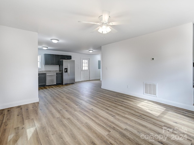 unfurnished living room featuring ceiling fan and light wood-type flooring