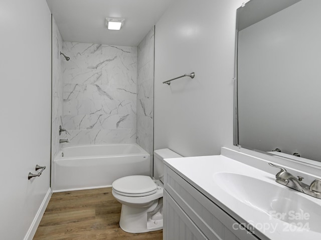 full bathroom with tiled shower / bath combo, toilet, wood-type flooring, and vanity