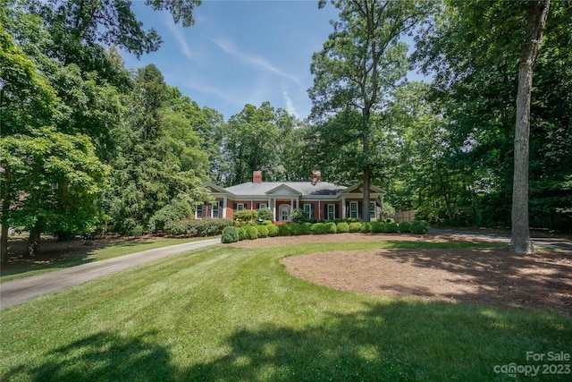 ranch-style home featuring a front yard