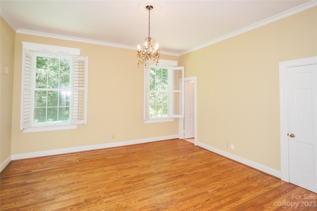 unfurnished room featuring a notable chandelier, light wood-type flooring, and a wealth of natural light