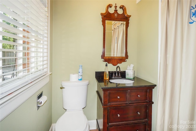 bathroom featuring toilet and vanity