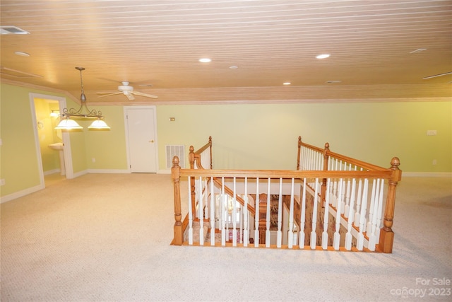 hall with light carpet and ornamental molding