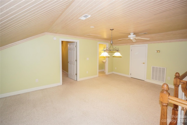 interior space featuring ceiling fan, light colored carpet, and wood ceiling