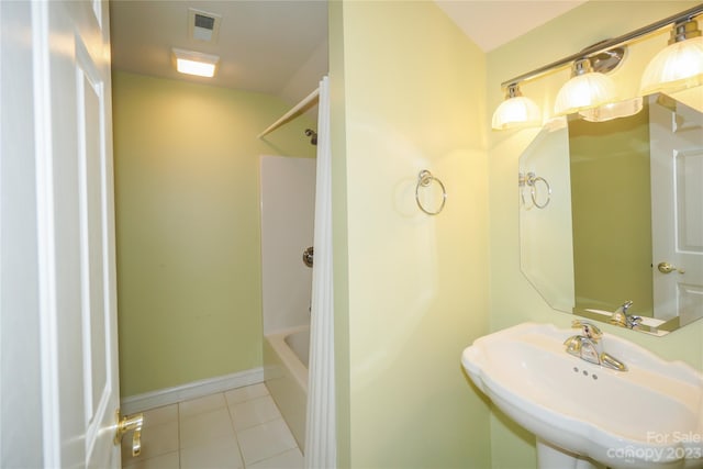 bathroom with sink, tile floors, and shower / tub combination