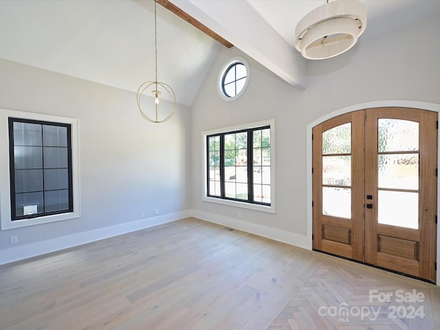 foyer featuring french doors, light wood-type flooring, beam ceiling, and high vaulted ceiling