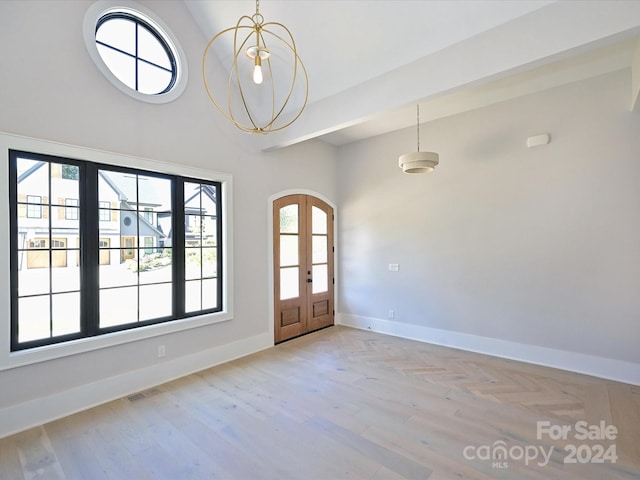 foyer featuring french doors, an inviting chandelier, and light wood-type flooring