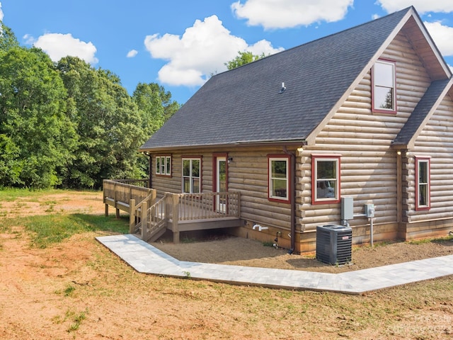 rear view of house with a deck and central AC