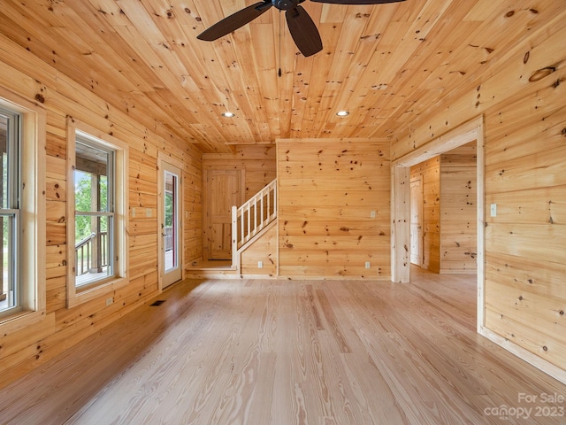 unfurnished room featuring wood ceiling, ceiling fan, and light hardwood / wood-style flooring