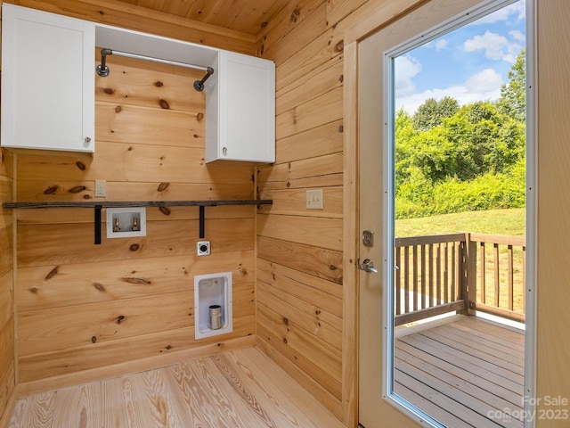 interior space with wood walls and light hardwood / wood-style flooring