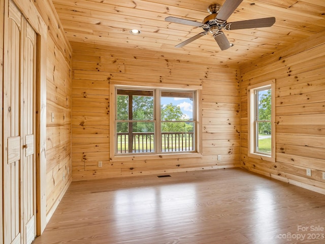 spare room with ceiling fan, light hardwood / wood-style flooring, and wood ceiling