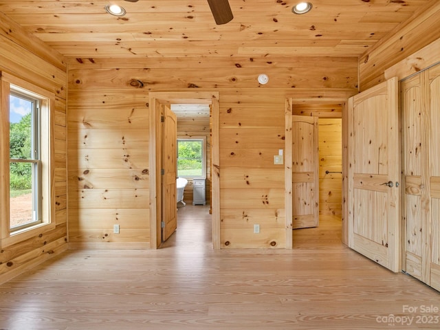 spare room with wooden ceiling, light hardwood / wood-style floors, ceiling fan, and a wealth of natural light