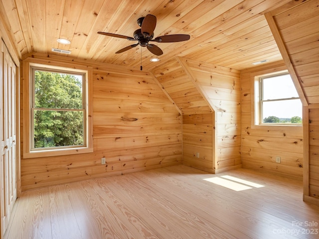 additional living space with wood ceiling, lofted ceiling, and light hardwood / wood-style floors