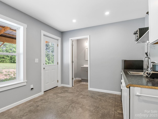 interior space featuring white cabinets and sink