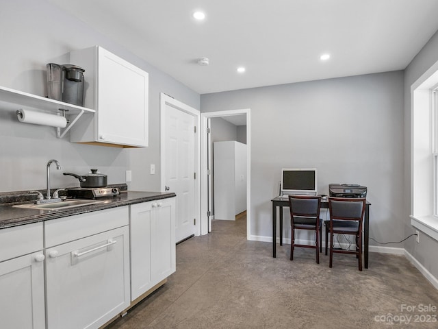 kitchen featuring white cabinetry and sink