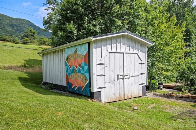 view of shed / structure with a lawn